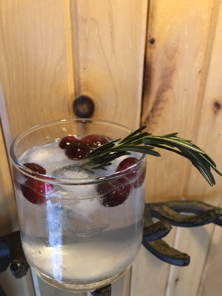 Mistletoe cocktail with frozen cranberries and rosemary