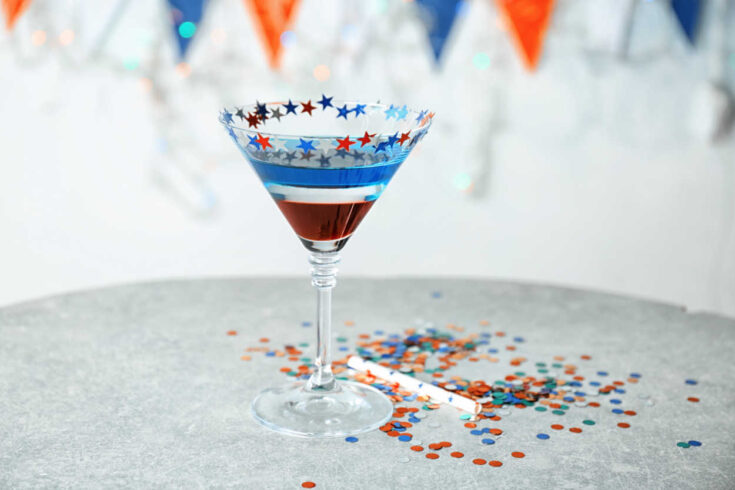 Red white and blue martini Layered cocktail in colors of American flag on table
