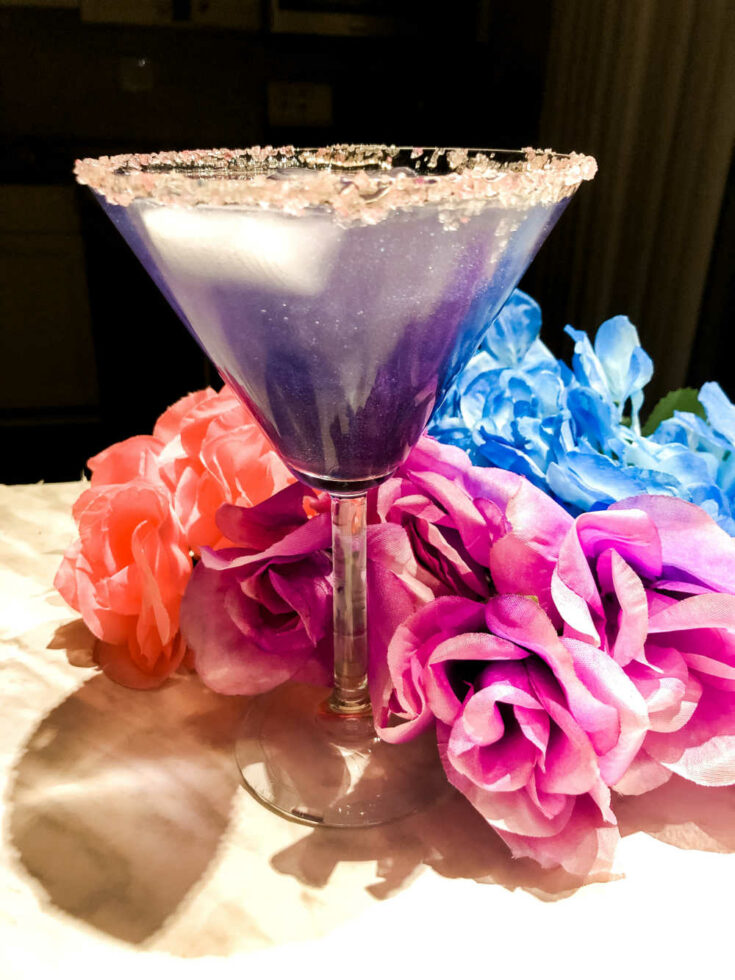 Encanto cocktail with colored flowers