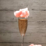 champagne cocktail with cotton candy garnish