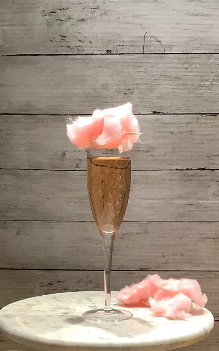 champagne cocktail with cotton candy garnish